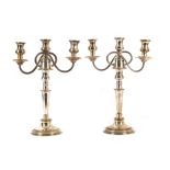 A pair of silver plated three candle candelabra