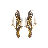 A pair of early 20th Century carved and parcel gilt wall sconces