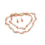 A coral-set necklace and earrings