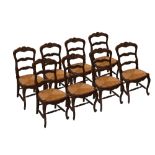 A set of eight French rustic oak ladder back dining chairs