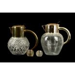 Two silver plated and glass water jugs and two silver match strikers