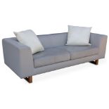 Linley: a three seater sofa upholstered in grey leather