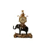 A ROCOCO STYLE GILT AND PATINATED BRONZE MANTEL CLOCK MODELLED AS AN ELEPHANT AND RIDER