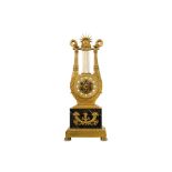 A LATE 19TH CENTURY FRENCH EMPIRE STYLE GILT BRONZE AND MARBLE LYRE CLOCK