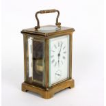 A gilt brass cased carriage clock, the white enamel dial with subsidiary dial,