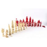 A 19th Century carved natural and red stained ivory part chess set,