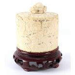 A Japanese cylindrical ivory box and cover carved all over with tiger's heads, 8cm high, (no base),