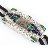 A lady's Art Deco cocktail watch of rectangular shape set with emeralds, sapphires and diamonds,