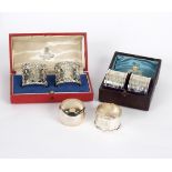 Two pairs of cased silver napkin rings,