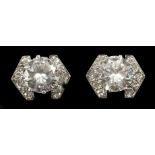 A pair of diamond ear studs, each with central stone of approximately 1.