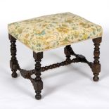 An upholstered stool on baluster turned legs,