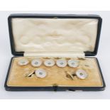A gentleman's diamond and mother-of-pearl dress set, AW, the five buttons set in 9ct rose gold,