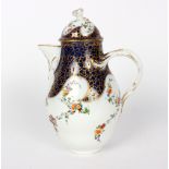 A Meissen coffee pot and cover, of ogee form, painted flower sprigs on a blue and gilt ground,