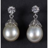 A pair of pearl and diamond drop earrings,