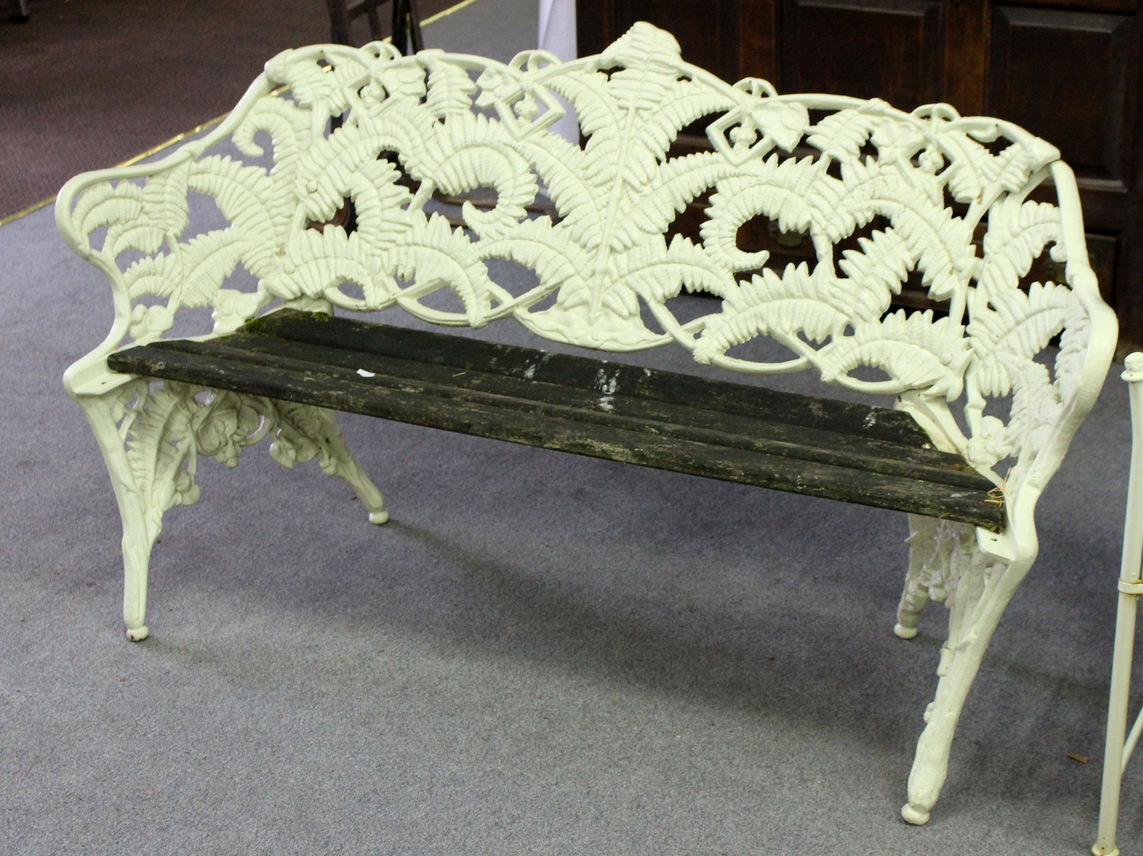 A fern pattern cast iron garden seat in the style of Coalbrookdale, with slatted wooden seat,