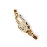 A lady's 9ct gold cased wristwatch, the oval silvered dial with Arabic numerals,