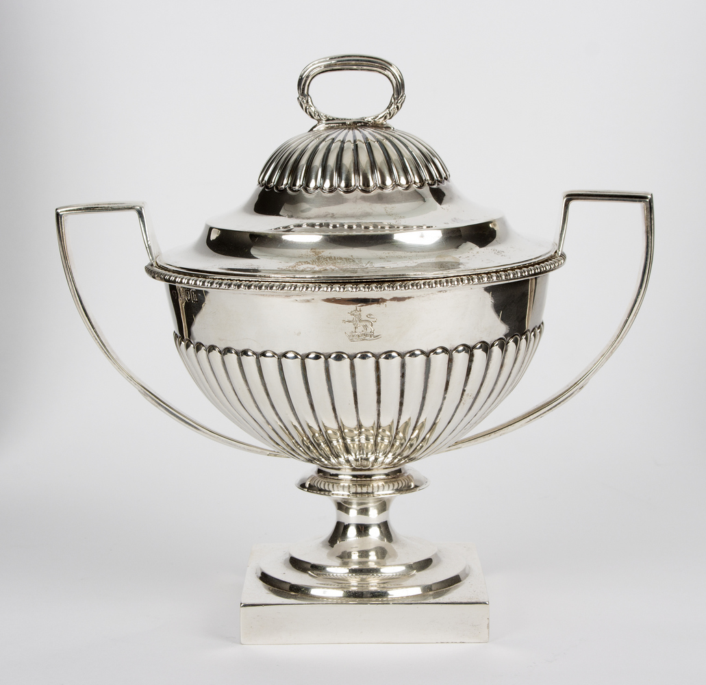 A silver two-handled bowl and cover, MF, London 1903, with half-ribbed decoration, crested,