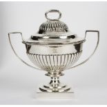 A silver two-handled bowl and cover, MF, London 1903, with half-ribbed decoration, crested,
