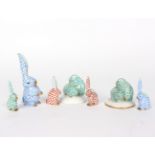 A group of seven Herend rabbits in red, blue and green,