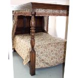 An oak four poster bed of Elizabethan design with moulded canopy,