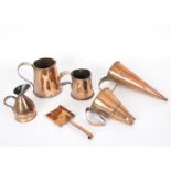 A copper ale warmer of conical form, two copper mugs,