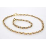 An Italian 18ct gold bi-colour necklace and bracelet of rope twist form,