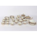 A English porcelain tea service, circa 1810, with a wide blue and gold floral border,