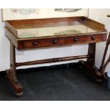 A Regency mahogany dressing table on tapered end standards united by a turned stretcher,