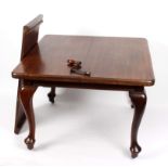 A Victorian mahogany extending dining table with one leaf and winder, on cabriole legs,