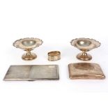 Two silver pedestal dishes, London 1922, a napkin ring and two cigarette cases,