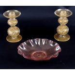 A pair of gold-flecked Murano glass candlesticks, with wrythen globular stems,