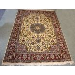 A modern Persian carpet with central floral field on a camel ground,