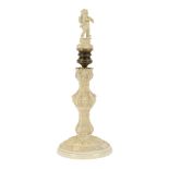 A fine 18th Century carved ivory candlestick of Rococo style, carved with putto mask heads,