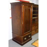 A mahogany linen press, the panel door now fitted for hanging space, with drawer below,