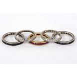 A diamond eternity ring set in precious white metal, size P½, another similar (lacking a stone),