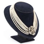 A diamond and pearl necklace, the seven rows of cultured pearls centred by a diamond flowerhead,