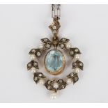 An Edwardian aquamarine pendant in a diamond and pearl wreath surround,