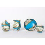 A Sèvres cream jug, the turquoise ground with an oval shaped reserve of exotic birds,
