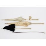 A black lace parasol, the ivory handle carved grapes and vines,