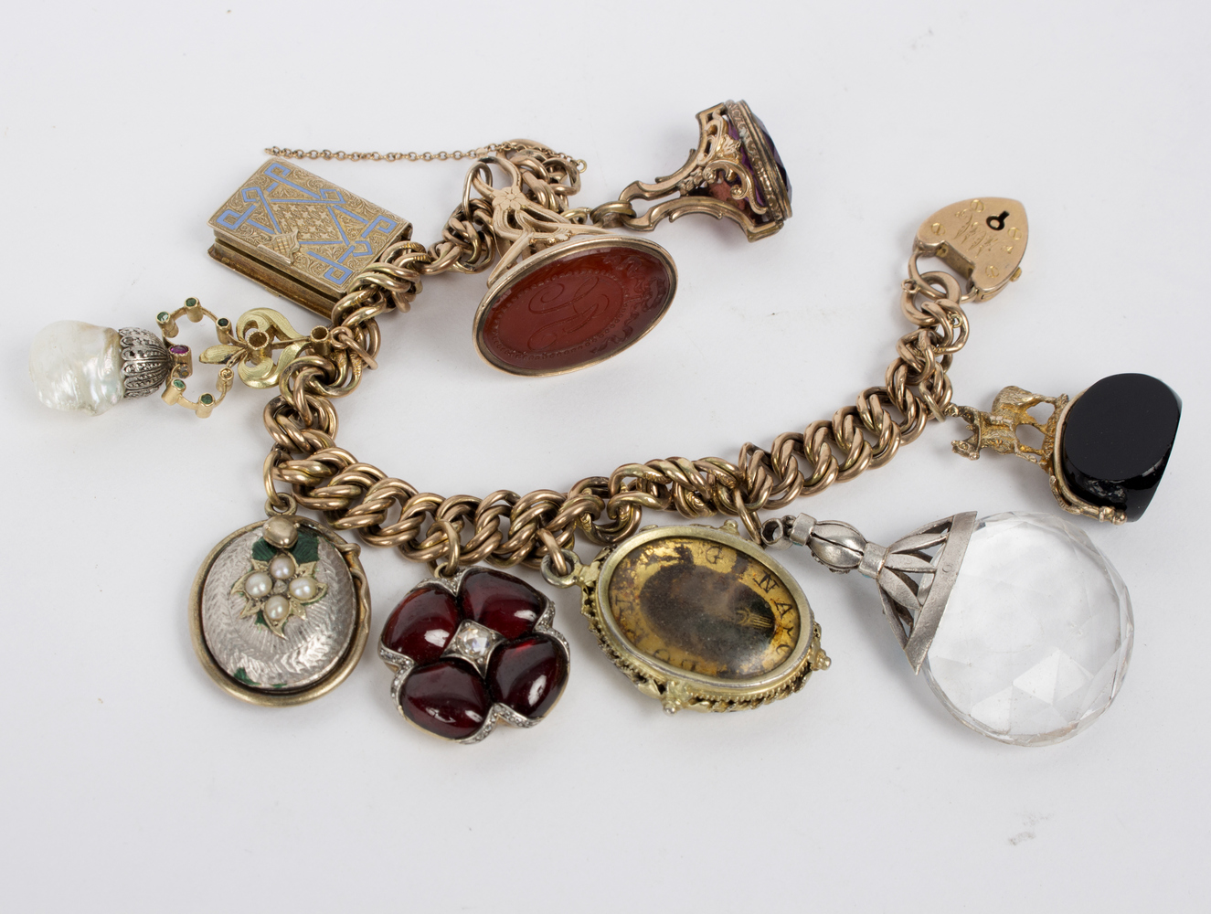 A 9ct gold fancy link bracelet hung with pendants, lockets and seal fobs, - Image 2 of 2