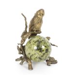A desk ornament modelled as a parrot on a naturalistic branch above a veined hardstone sphere, 14.