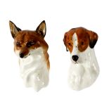 A pair of Royal Worcester fox and hound wall masks,