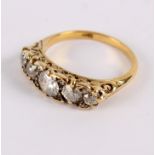 A diamond five-stone ring, in an 18ct yellow gold scroll setting, central stone of 0.