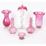 A pair of mottled pink glass vases each with trails of decoration to the necks, 16cm high,