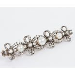A pearl and diamond bar brooch adapted from a bracelet,