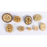 Nine Victorian ivory brooches, mostly Cantonese, carved figures in garden landscapes,