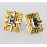 A pair of sapphire ear studs in bi-coloured gold rectangular settings,