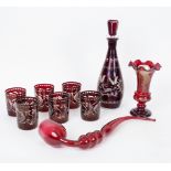 A Bohemian red glass decanter and stopper decorated a leaping stag, 33.