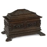 A 19th Century carved oak cassone of sarcophagus form, carved panels of winged beasts,