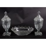 A pair of cut glass jars and covers and an oval bowl, 19th Century,